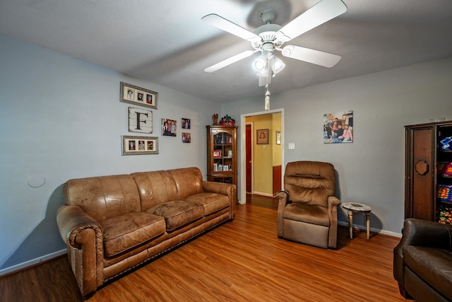 living room with ceiling fan and hardwood / wood-style flooring