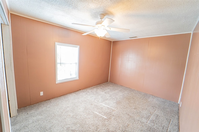 carpeted empty room with a textured ceiling and ceiling fan