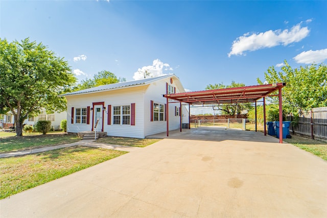 view of front facade with a front yard and a carport