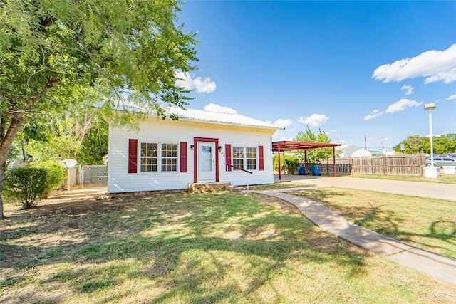 view of front of home with a pergola and a front yard