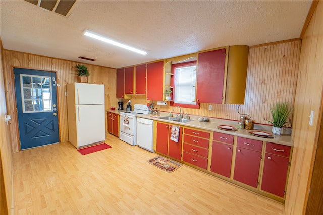 kitchen with sink, light hardwood / wood-style flooring, a textured ceiling, and white appliances