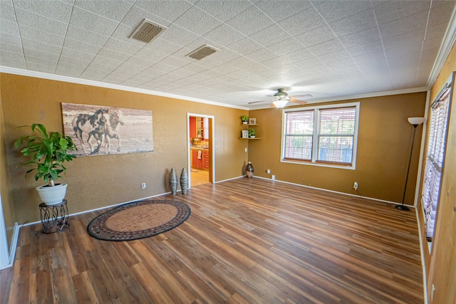 unfurnished room with ceiling fan, ornamental molding, and wood-type flooring