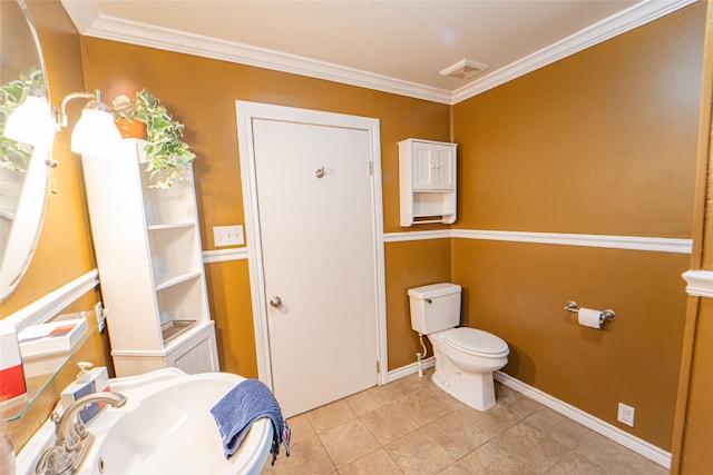 bathroom with sink, toilet, tile patterned flooring, and ornamental molding