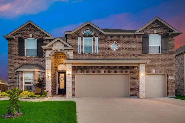 view of front of property featuring a lawn and a garage