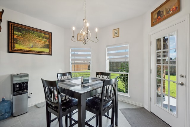 dining area featuring a notable chandelier and light tile patterned floors