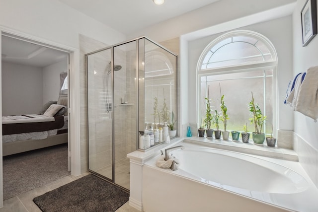 bathroom featuring tile patterned flooring and independent shower and bath