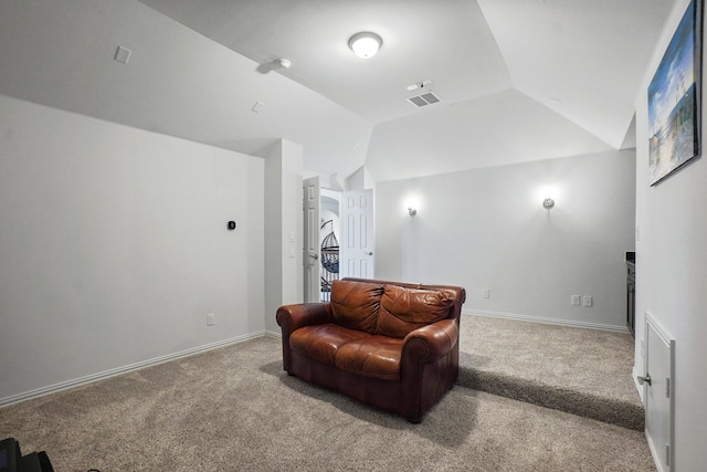 living area featuring vaulted ceiling and carpet floors