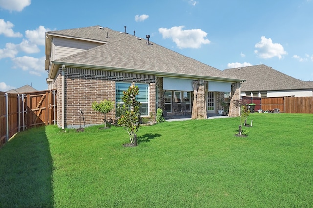 back of house featuring a yard