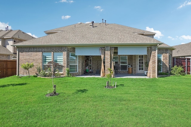 rear view of property with a patio and a yard