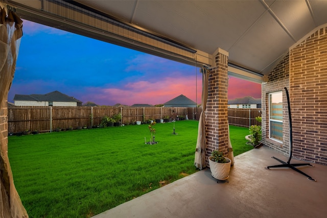 yard at dusk with a patio