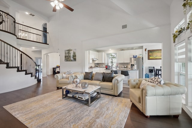 living room with ceiling fan, high vaulted ceiling, and wood-type flooring