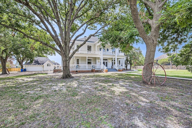 view of front of home featuring a porch and fence