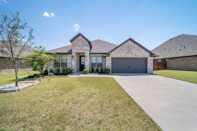 view of front of home featuring a front lawn and a garage