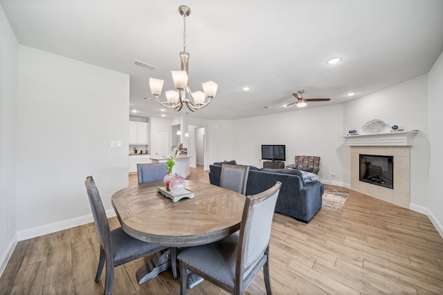 dining area featuring a notable chandelier and light hardwood / wood-style flooring