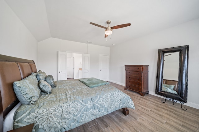 bathroom featuring vanity, tile patterned floors, vaulted ceiling, and shower with separate bathtub