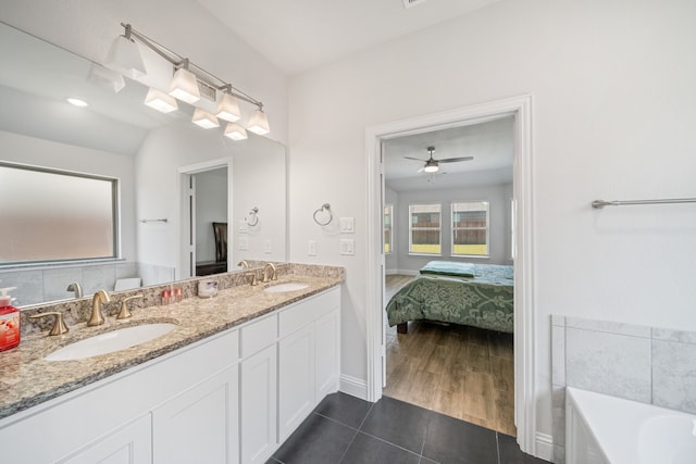 bathroom with vanity, tile patterned floors, vaulted ceiling, and separate shower and tub