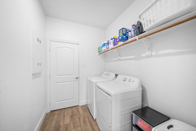 laundry area featuring light hardwood / wood-style flooring and washing machine and clothes dryer