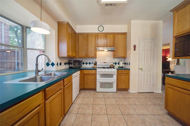 kitchen featuring white appliances, decorative light fixtures, backsplash, light tile patterned floors, and sink