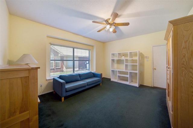 living area with ceiling fan and dark colored carpet