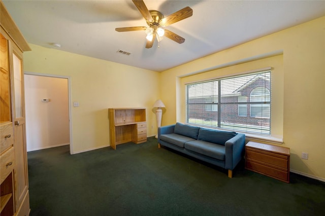 living area with dark carpet and ceiling fan