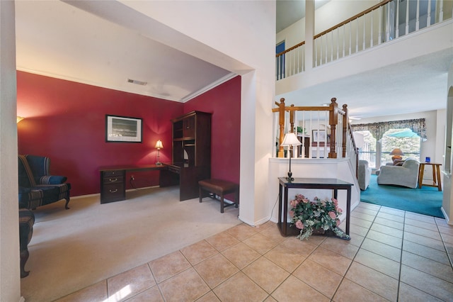 interior space with ornamental molding and tile patterned flooring