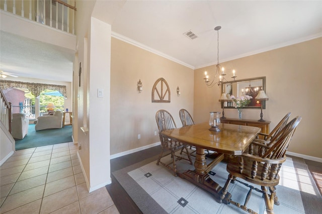 dining area featuring an inviting chandelier, light tile patterned floors, and ornamental molding