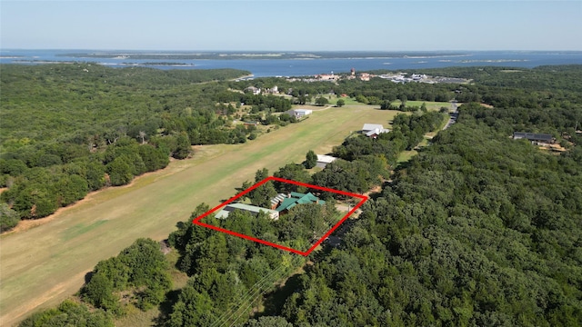 aerial view with a water view and a forest view