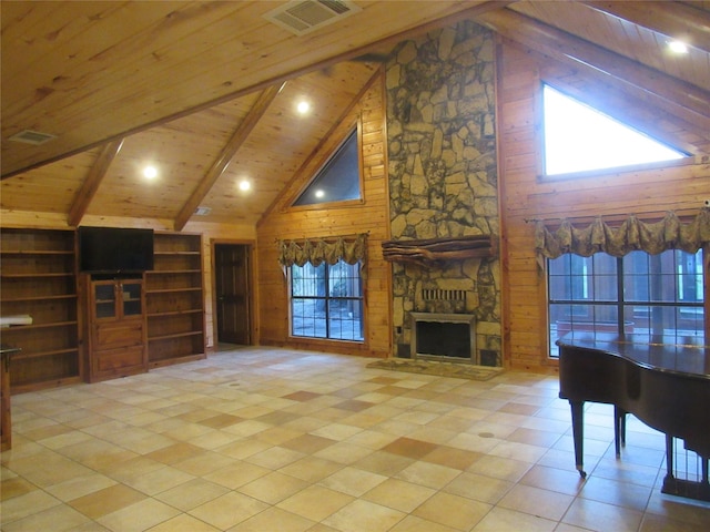 living room featuring visible vents, wood ceiling, wooden walls, a stone fireplace, and beamed ceiling