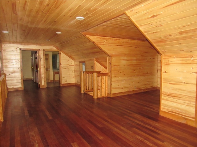 bonus room featuring wood walls, vaulted ceiling, dark hardwood / wood-style floors, and wooden ceiling