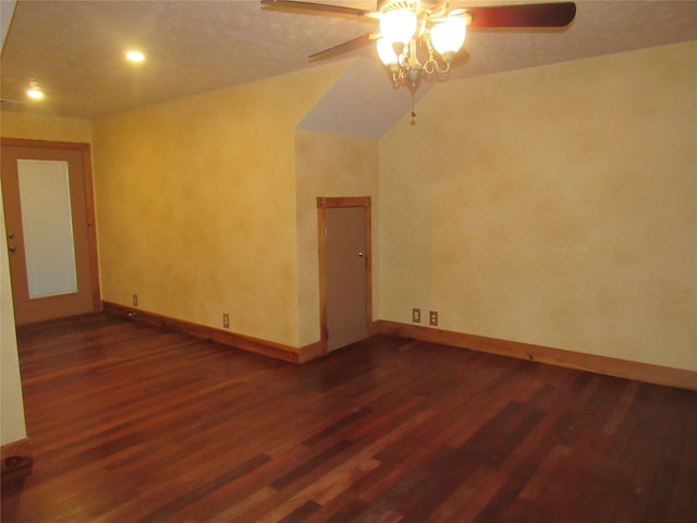 unfurnished room featuring lofted ceiling, a ceiling fan, baseboards, and dark wood-style flooring