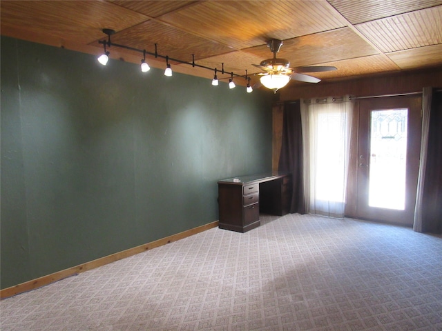 spare room with ceiling fan, wooden ceiling, light carpet, baseboards, and rail lighting