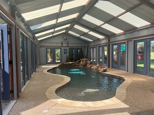 pool with french doors and a hot tub