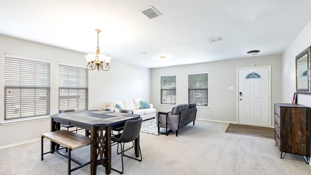 carpeted dining room with a wealth of natural light and a notable chandelier