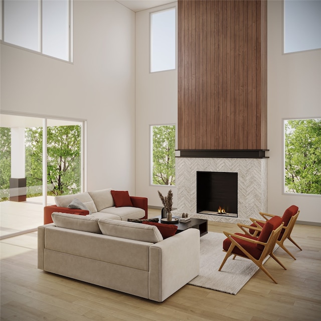 living room featuring plenty of natural light, light hardwood / wood-style floors, and a tile fireplace