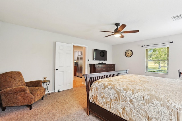 carpeted bedroom featuring ceiling fan and stainless steel fridge