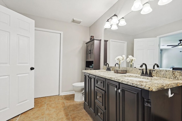 bathroom featuring ceiling fan, toilet, and vanity