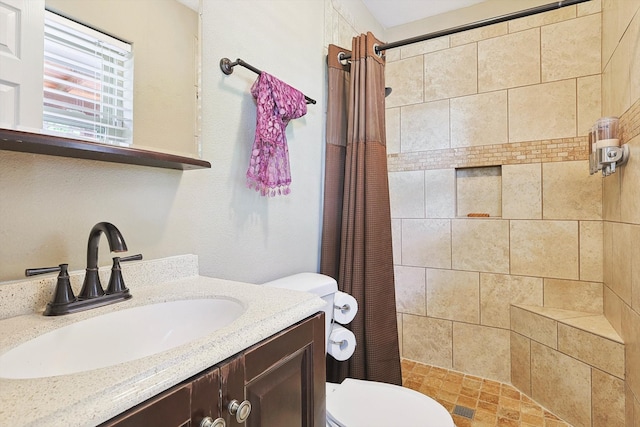 bathroom with toilet, vanity, and a shower with curtain