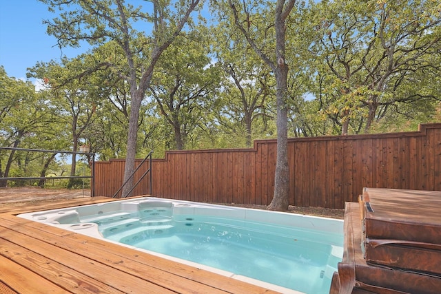 view of swimming pool with a wooden deck