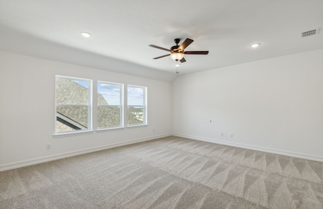 spare room featuring ceiling fan and light carpet