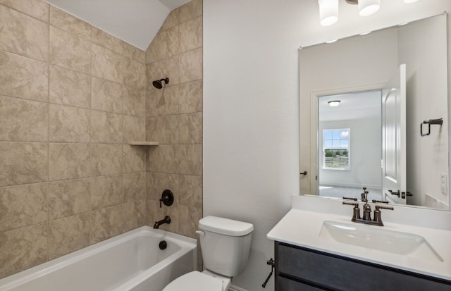 full bathroom featuring toilet, vanity, vaulted ceiling, and tiled shower / bath