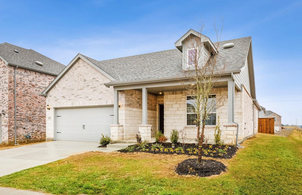 view of front of house with a garage and a front lawn