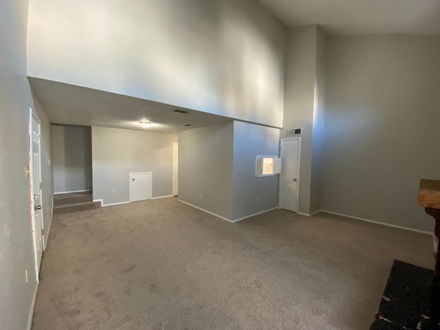 interior space featuring carpet floors and a high ceiling