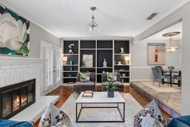 living room with a brick fireplace, crown molding, and hardwood / wood-style floors