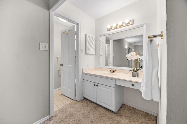 bathroom with tile patterned flooring and vanity