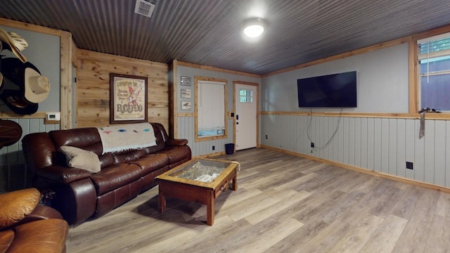 living room with wood walls and hardwood / wood-style floors