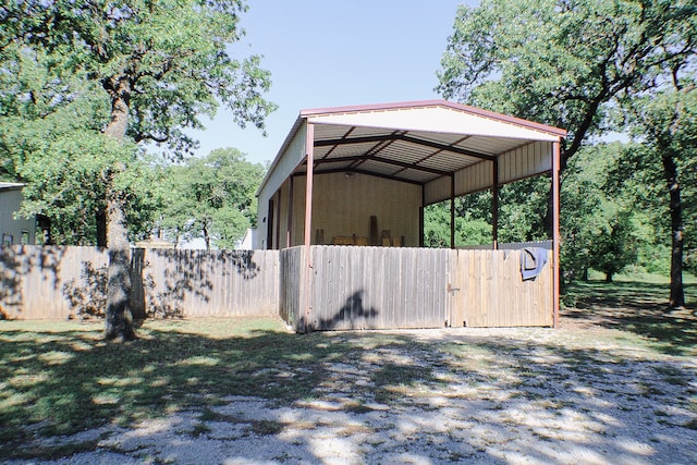 view of yard with a carport and an outdoor structure