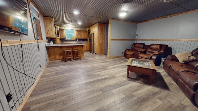 living room featuring light hardwood / wood-style flooring and crown molding