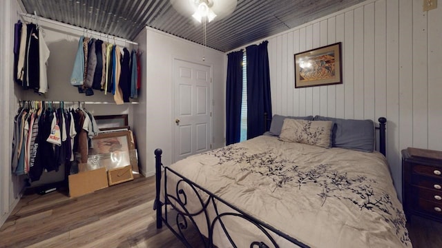 bedroom with ornamental molding, a closet, and wood-type flooring