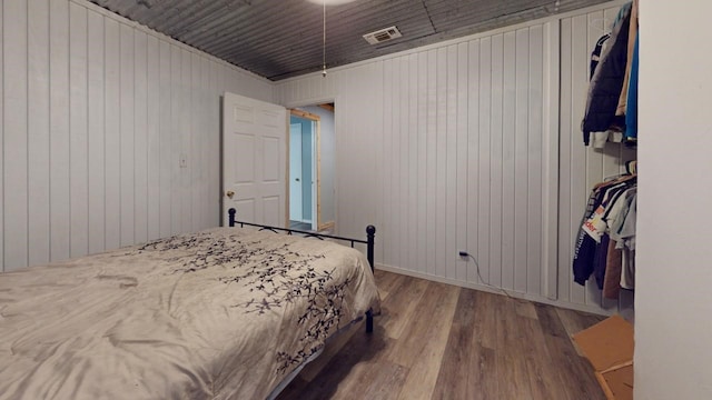 bedroom with a closet and hardwood / wood-style floors