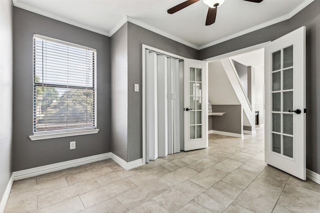 tiled spare room featuring ceiling fan, ornamental molding, and french doors